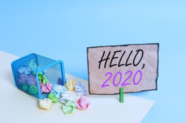 Handwriting text writing Hello 2020. Concept meaning expression or gesture of greeting answering the telephone Trash bin crumpled paper clothespin empty reminder office supplies tipped.