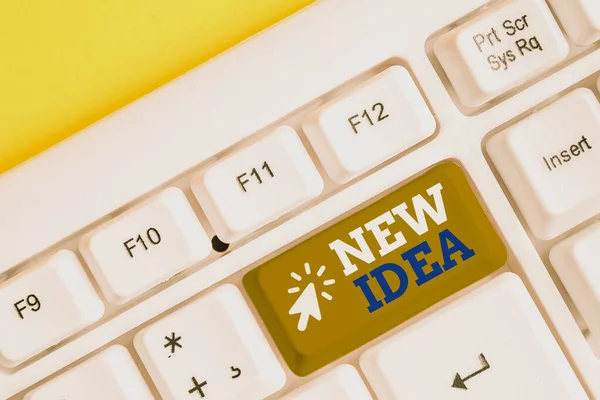 Writing note showing New Idea. Business photo showcasing A thought or conception refer to a product of mental activity White pc keyboard with note paper above the white background. — Stockfoto