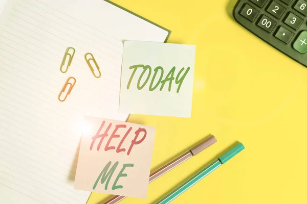 Text sign showing Help Me. Conceptual photo Asking someone to assist you Shouting for it Teamwork Volunteer Empty blue paper with copy space paper clips and pencils on the yellow table.