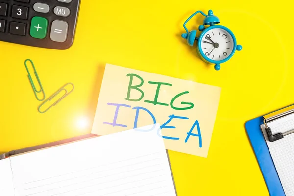 Text sign showing Big Idea. Conceptual photo Having great creative innovation solution or way of thinking Empty orange paper with copy space on the yellow table.