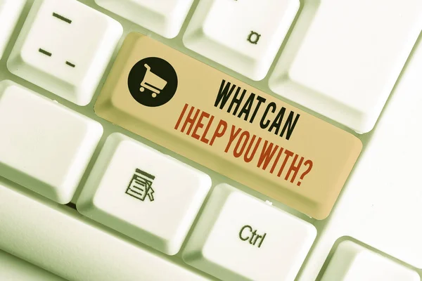 Text sign showing What Can I Help You With Question. Conceptual photo Offering assistance Experts advice ideas White pc keyboard with empty note paper above white background key copy space.