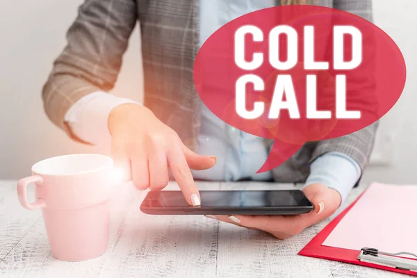 Text sign showing Cold Call. Conceptual photo Unsolicited call made by someone trying to sell goods or services Business woman sitting with mobile phone and cup of coffee on the table.