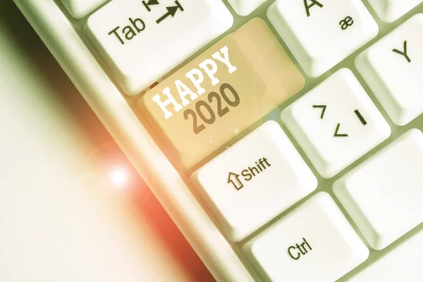 Writing note showing Happy 2020. Business photo showcasing time or day at which a new calendar year begin from now White pc keyboard with note paper above the white background. — Stock Photo, Image