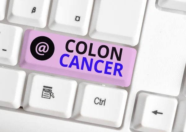Word writing text Colon Cancer. Business concept for the development of cancer cells from the colon or rectum White pc keyboard with empty note paper above white background key copy space.