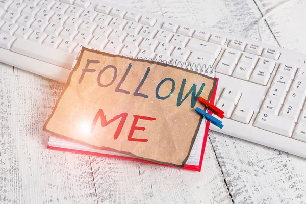 Text sign showing Follow Me. Conceptual photo Inviting a demonstrating or group to obey your prefered leadership notebook paper reminder clothespin pinned sheet white keyboard light wooden.