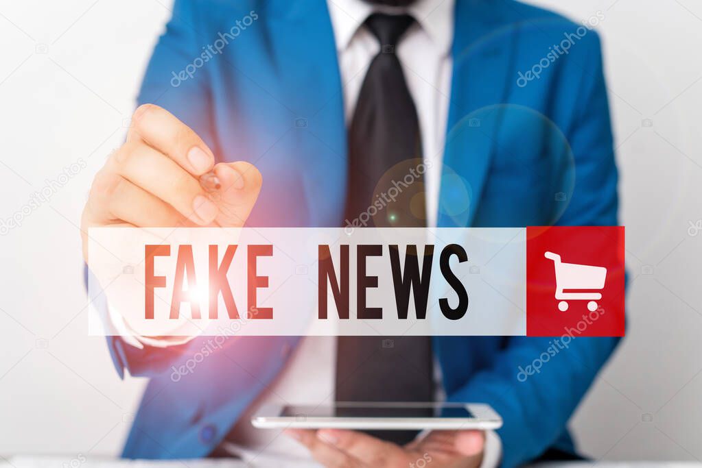 Word writing text Fake News. Business concept for Giving information to showing that is not true by the media Businessman pointing with pen in empty copy space.