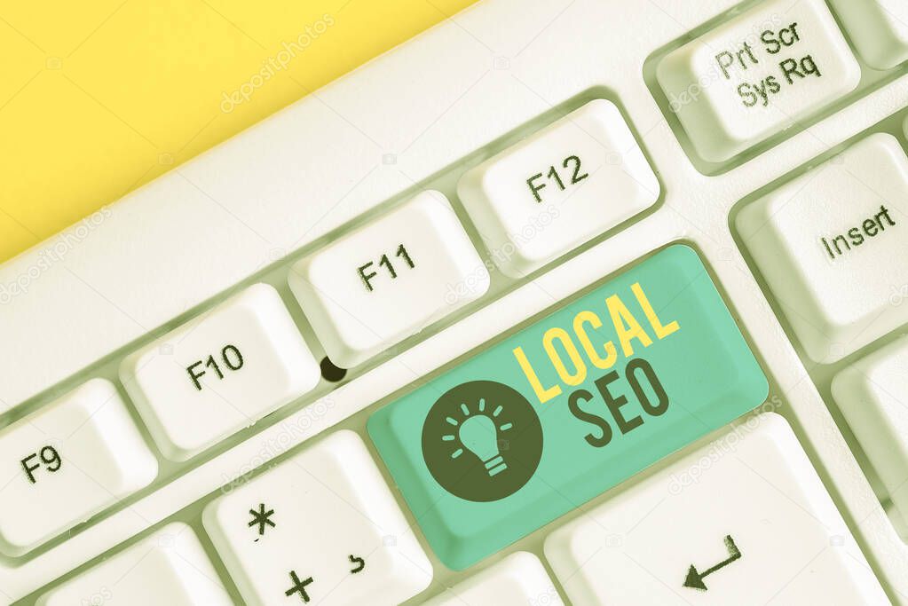 Conceptual hand writing showing Local Seo. Business photo showcasing This is an effective way of marketing your business online White pc keyboard with note paper above the white background.