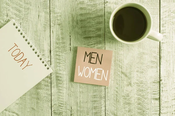 Conceptual hand writing showing Men Women. Business photo text The state where in a boy or a girl turns to be a mature adult Stationary placed next to a coffee cup above wooden table. — Stock Photo, Image