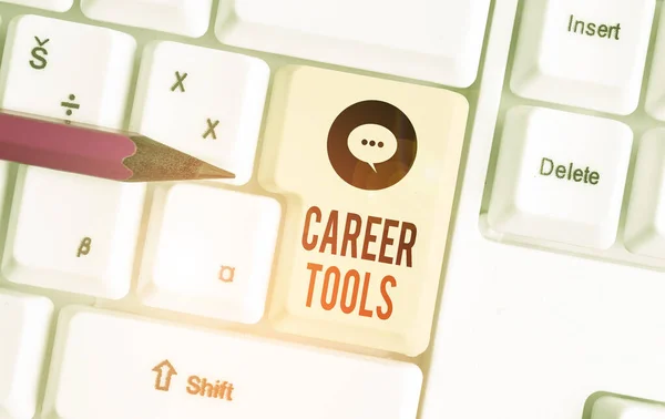 Writing note showing Career Tools. Business photo showcasing the system designed to assist and enhance your career White pc keyboard with note paper above the white background.
