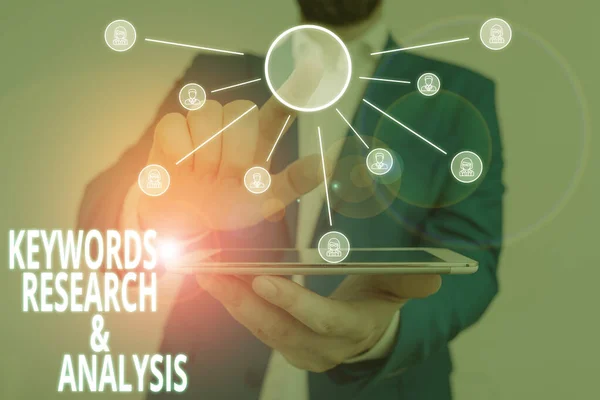 Word writing text Keywords Research And Analysis. Business concept for search for data and create tables graphs Male human wear formal work suit presenting presentation using smart device. — Stock Photo, Image