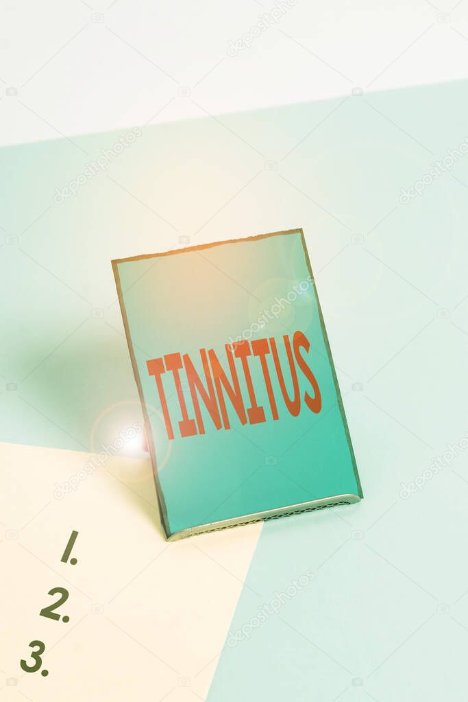 Writing note showing Tinnitus. Business photo showcasing A ringing or music and similar sensation of sound in ears.