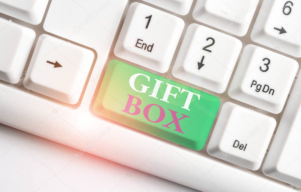 Text sign showing Gift Box. Conceptual photo A small cointainer with designs capable of handling presents White pc keyboard with empty note paper above white background key copy space.