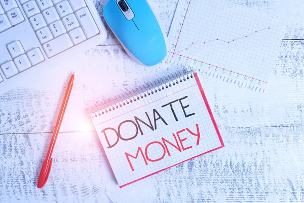 Conceptual hand writing showing Donate Money. Business photo text to give money or goods to help a demonstrating or organization Wood desk office appliance computer equipaments charts paper slot. — Stock fotografie