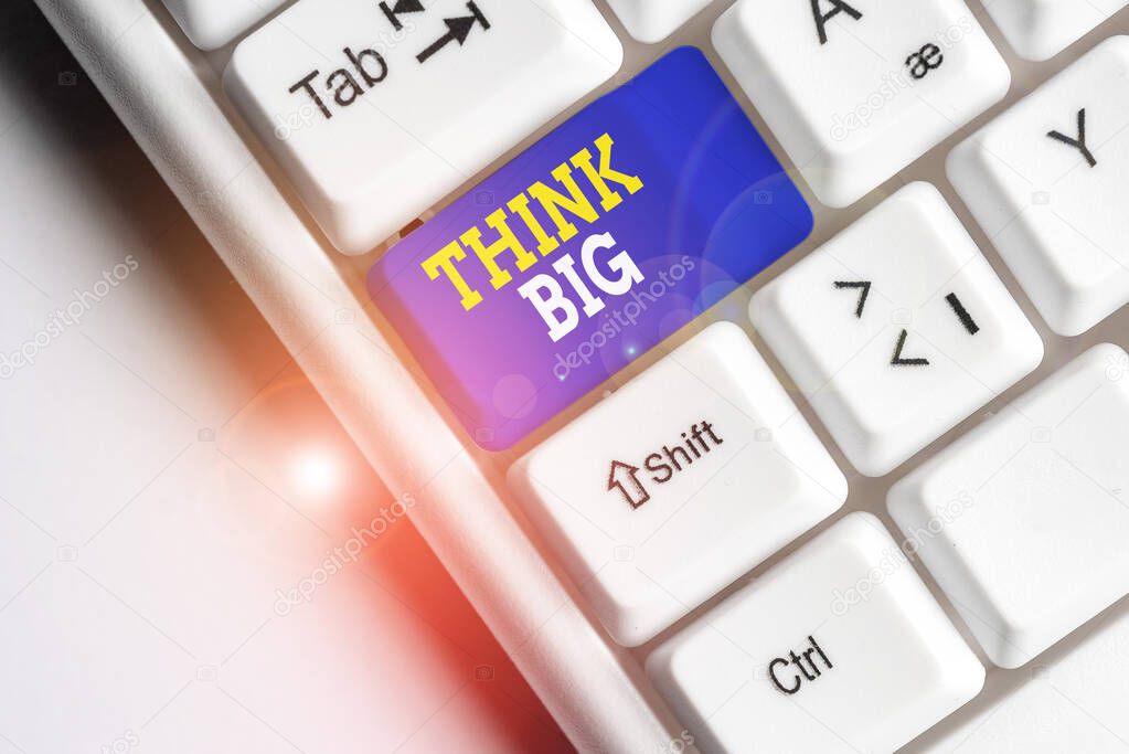 Conceptual hand writing showing Think Big. Business photo showcasing To plan for something high value for ones self or for preparation White pc keyboard with note paper above the white background.