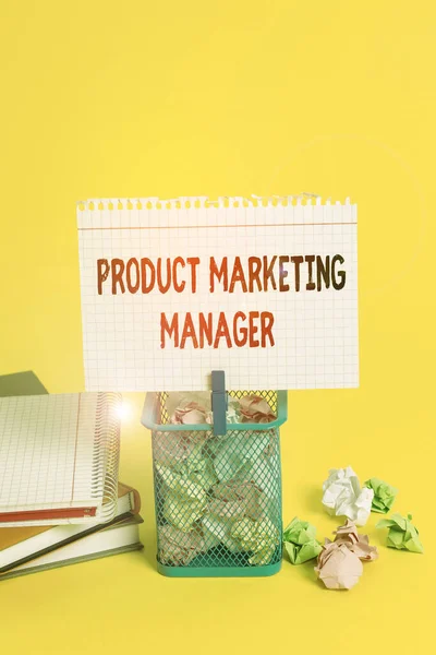 Handwriting text Product Marketing Manager. Concept meaning who responsible for putting plan to sell product Trash bin crumpled paper clothespin empty reminder office supplies yellow.