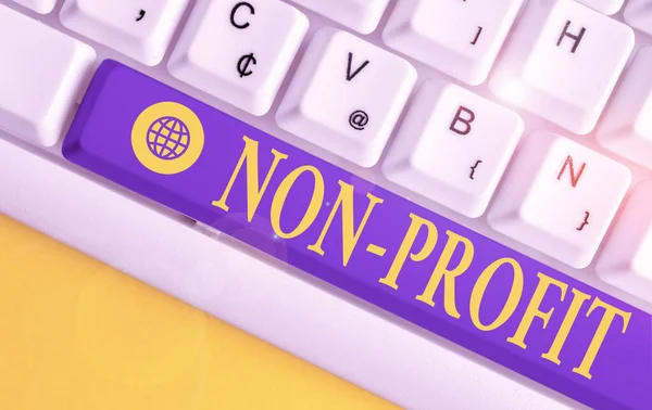 Text sign showing Non Profit. Conceptual photo type of organization that does not earn profits for its owners White pc keyboard with empty note paper above white background key copy space.