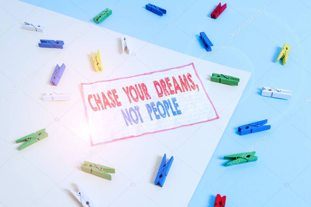 Conceptual hand writing showing Chase Your Dreams Not People. Business photo text Do not follow others chasing goals objectives Colored clothespin paper reminder with yellow blue background.