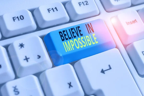 Text sign showing Believe In Impossible. Conceptual photo You can do it everything is possible Work hard White pc keyboard with empty note paper above white background key copy space. — Stock Photo, Image