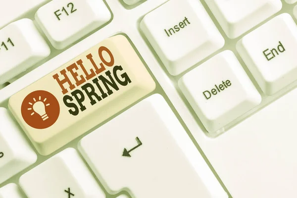 Word writing text Hello Spring. Business concept for welcoming the season of the blossoming of flowers End of winter White pc keyboard with empty note paper above white background key copy space. — Stock Photo, Image