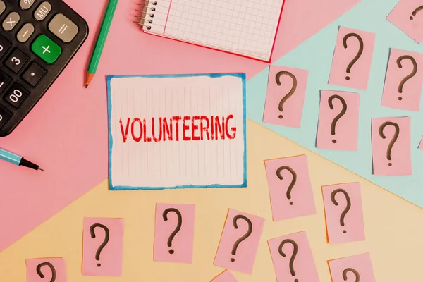 Writing note showing Volunteering. Business photo showcasing Provide services for no financial gain Willingly Oblige Mathematics stuff and writing equipment above pastel colours background. — Stock Photo, Image