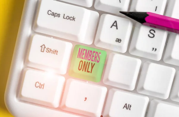 Text sign showing Members Only. Conceptual photo Limited to an individual belongs to a group or an organization White pc keyboard with empty note paper above white background key copy space.