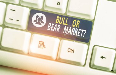 Boğa ya da Ayı Pazarı Sorusu 'nu yazan el yazısı. Kavram, birine pazarlama yöntemi hakkında beyaz arkaplan anahtar alanının üzerinde boş not kağıdı bulunan beyaz pc klavye sormaktır.