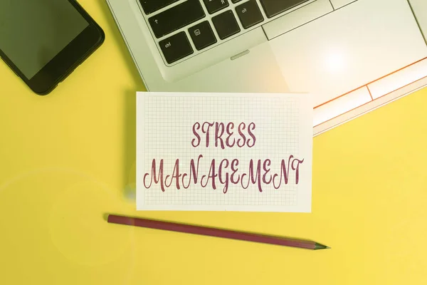 Text sign showing Stress Management. Conceptual photo method of limiting stress and its effects by learning ways Metallic laptop pencil squared paper sheet smartphone colored background.