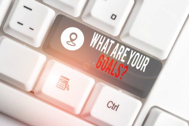 Conceptual hand writing showing What Are Your Goals Question. Business photo text ask the Desired End Results to know the plans White pc keyboard with note paper above the white background.