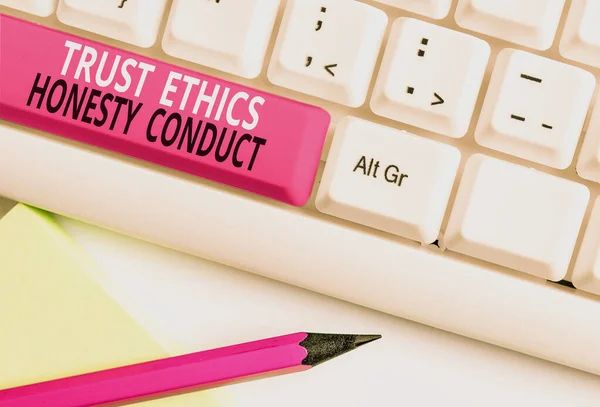 Conceptual hand writing showing Trust Ethics Honesty Conduct. Business photo text connotes positive and virtuous attributes White pc keyboard with note paper above the white background. — Stok fotoğraf
