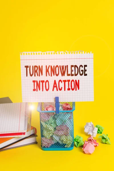 Handwriting text Turn Knowledge Into Action. Concept meaning Apply what you have learned Leadership strategies Trash bin crumpled paper clothespin empty reminder office supplies yellow.