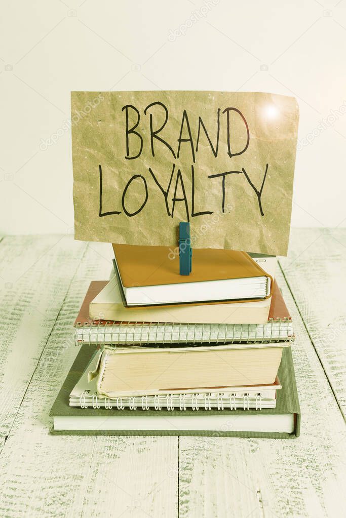 Writing note showing Brand Loyalty. Business photo showcasing Repeat Purchase Ambassador Patronage Favorite Trusted pile stacked books notebook pin color reminder white wooden.