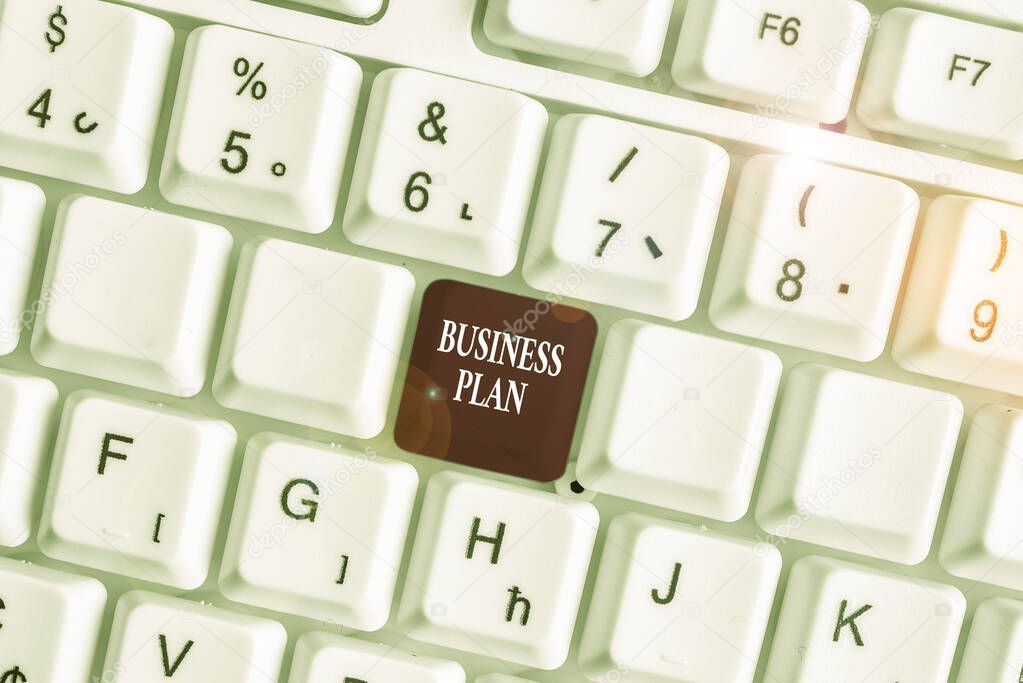 Text sign showing Business Plan. Conceptual photo Structural Strategy Goals and Objectives Financial Projections White pc keyboard with empty note paper above white background key copy space.