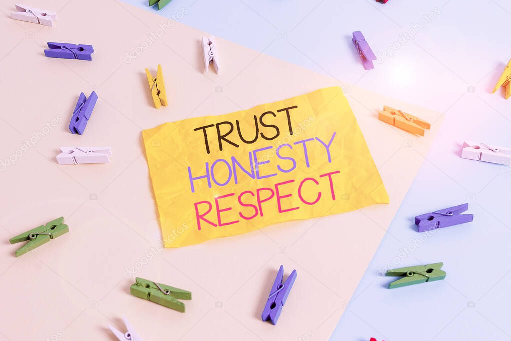 Handwriting text writing Trust Honesty Respect. Concept meaning Respectable Traits a Facet of Good Moral Character Colored clothespin paper empty reminder yellow blue floor background office.