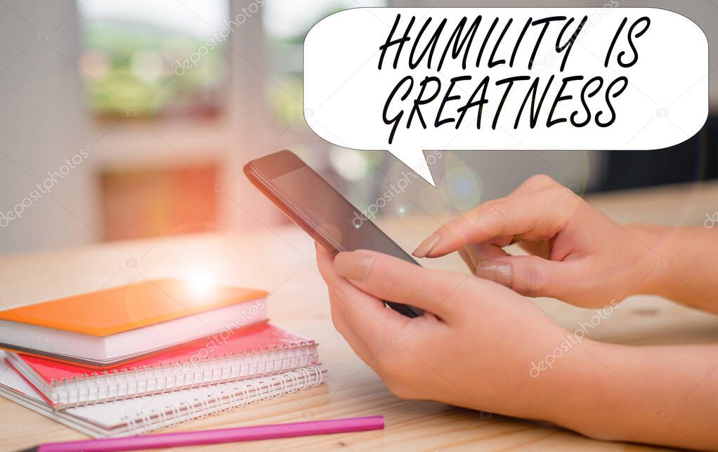Conceptual hand writing showing Humility Is Greatness. Business photo text being Humble is a Virtue not to Feel overly Superior woman using smartphone and technological devices inside the home.