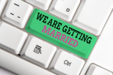 Handwriting text writing We Are Getting Married. Concept meaning Engagement Wedding preparation Loving couple White pc keyboard with empty note paper above white background key copy space. clipart