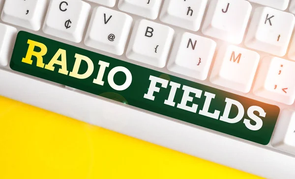 Writing note showing Radio Fields. Business photo showcasing electromagnetic field intensity consisting of an electric White pc keyboard with note paper above the white background.