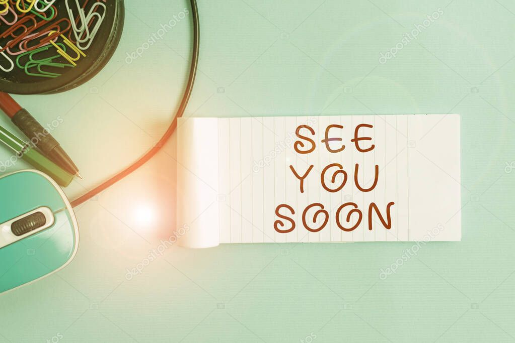 Handwriting text See You Soon. Conceptual photo used for saying goodbye to someone and going to meet again soon Notebook and writing equipment with computer mouse above pastel backdrop