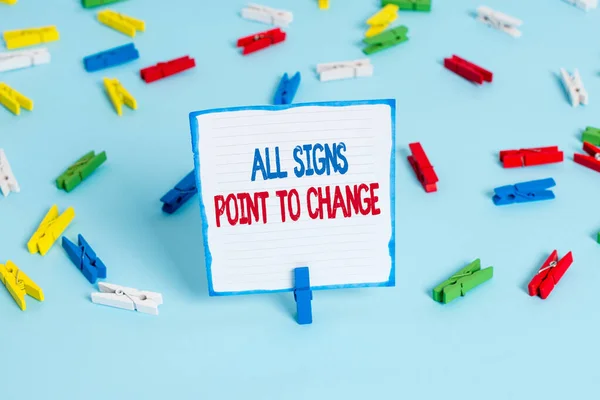 Conceptual hand writing showing All Signs Point To Change. Business photo text Necessity of doing things differently new vision Colored clothespin papers empty reminder blue floor officepin.