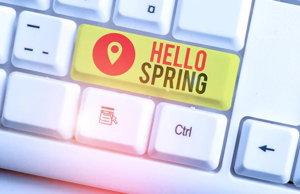 Text sign showing Hello Spring. Conceptual photo welcoming the season of the blossoming of flowers End of winter White pc keyboard with empty note paper above white background key copy space. — ストック写真