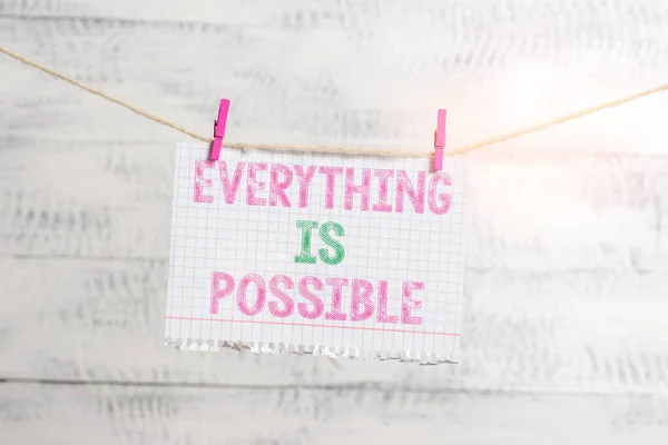 Writing note showing Everything Is Possible. Business photo showcasing Any outcome could occur Anything can happen Clothesline clothespin rectangle shaped paper reminder white wood desk. — Stock Photo, Image