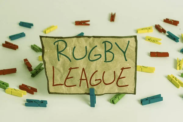 Word writing text Rugby League. Business concept for form of rugby football played between teams of 13 players Colored clothespin papers empty reminder white floor background office.