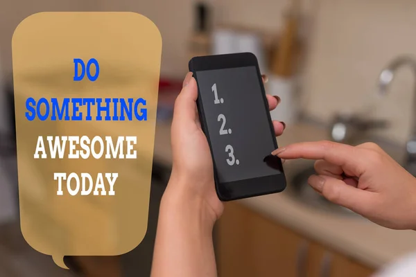 Writing note showing Do Something Awesome Today. Business photo showcasing Make an incredible action motivate yourself woman using smartphone and technological devices inside the home. — ストック写真