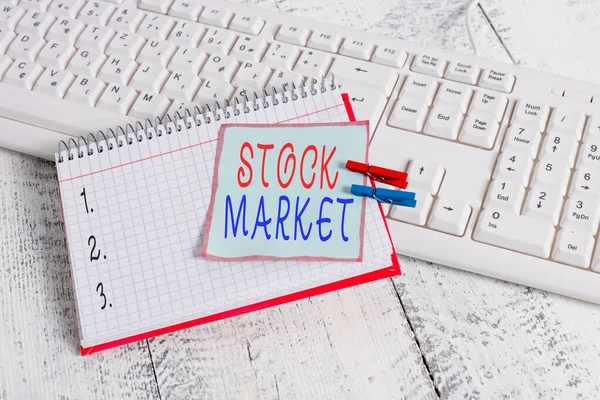 Conceptual hand writing showing Stock Market. Business photo showcasing traders buy and sell shares of companies on a public exchange notebook reminder clothespin with pinned sheet light wooden. — Stok fotoğraf