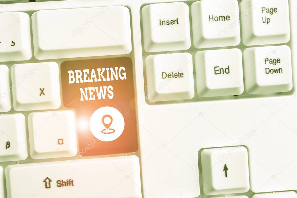 Conceptual hand writing showing Breaking News. Business photo text Special Report Announcement Happening Current Issue Flashnews White pc keyboard with note paper above the white background.