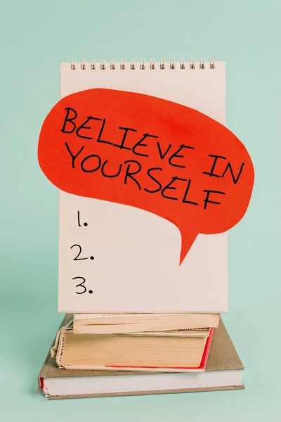 Writing note showing Believe In Yourself. Business photo showcasing common piece of advice that you can do everything Spiral notebook speech bubble stacked old books cool pastel background. — Stok fotoğraf