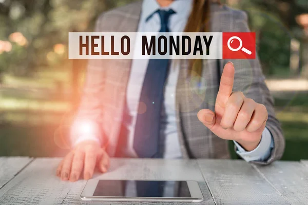 Word writing text Hello Monday. Business concept for greetings or welcoming the first day of the work week Female business person sitting by table holding mobile phone. — 스톡 사진