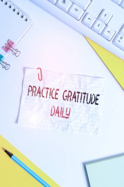 Word writing text Practice Gratitude Daily. Business concept for be grateful to those who helped encouarged you Flat lay above table with pc keyboard and copy space paper for text messages.