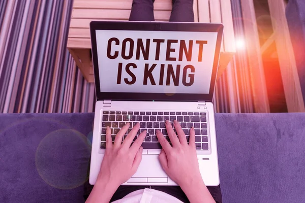 Writing note showing Content Is King. Business photo showcasing believe that content is central to the success of a website woman laptop computer office supplies technological devices inside home.