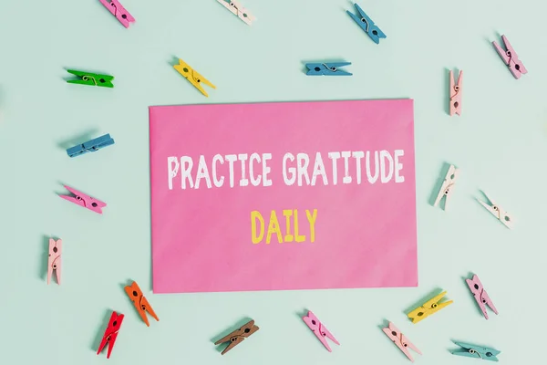 Conceptual hand writing showing Practice Gratitude Daily. Business photo showcasing be grateful to those who helped encouarged you Colored clothespin rectangle shaped paper blue background. — ストック写真
