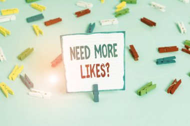 Conceptual hand writing showing Need More Likes Question. Business photo text asking if he needs additional reaction on his post Colored clothespin papers empty reminder blue floor officepin.